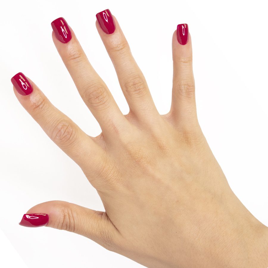Female hand with long nails and a bottle of dark red nail polish Stock  Photo - Alamy